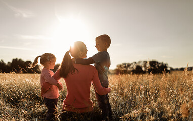 happy single mother and her children in nature