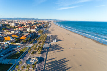 Aerial view of the beach of valencia and the coastline, late afternoon with waves, Spain