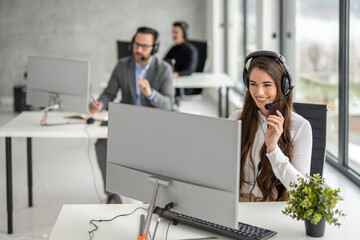 Wall Mural - Customer support phone operator woman working at computer at call center