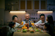 © imtmphoto - happy three generation asian family toasting while having dinner together