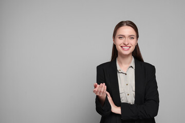 Canvas Print - Portrait of beautiful young teacher on grey background. Space for text