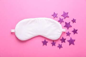 Poster - Soft sleep mask and decorative stars on pink background, flat lay