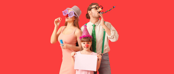 Poster - Happy family in funny disguise and with blank paper sheet on red background. April Fools Day