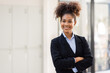 © David - Portrait of Young beautiful positive african american woman standing with arms crossed in office