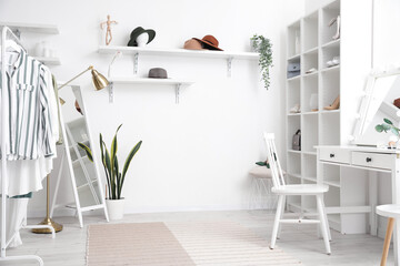 Sticker - Interior of stylish dressing room with table, shelving unit and clothes