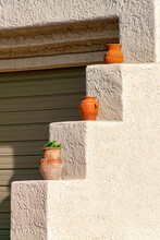 Terraced Wall With Ledges And Decorative Pots And Vases In Desert Or Mexican Style For Housing Plants