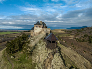 Wall Mural - Aerial view of partially restored Boldogko, medieval Gothic castle in Borsod county Hungary with round gate tower, donjon cloudy blue sky background