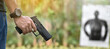 © Sophon_Nawit - 9mm automatic pistol holding in right hand of shooter at the shooting range, concept for security, robbery, gangster, bodyguard training. selective focus on pistol.