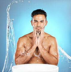 Canvas Print - Water splash, face and man with basin for beauty, skin and skincare cleaning body and topless. Mexican, male and wellness model with moisture, cleanse and hydration isolated in studio blue background