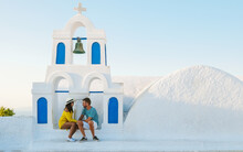Young Couple Tourist Visit Oia Santorini Greece During Summer With Whitewashed Homes And Churches