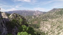 Low Level Aerial View Revealing High Mountain Peaks And Mediterranean Forest. Grenade. Spain.