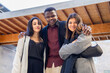 © Clàudia Ayuso - Portrait of attractive coworkers outside the office. Group of three young friends and partners posing at workplace outdoor in the city. Ethnic diversity and social inclusion.