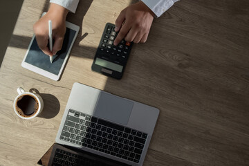 Wall Mural - businessman using a calculator top view, calculating user expenses, budgeting, and loan accounting 