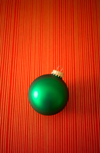 Green Christmas Ornament On Red Striped Background