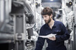 © Cavan Images - Young male engineer working in an industrial plant, Freiburg im Breisgau, Baden-Württemberg, Germany