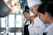 Portrait of a group of chefs and culinary students in the culinary Institute's kitchen.
