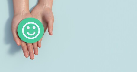 Fototapete - Hands holding green happy smile face paper cut, good feedback rating,think positive, customer review, assessment, child wellness,world mental health day, Compliment Day