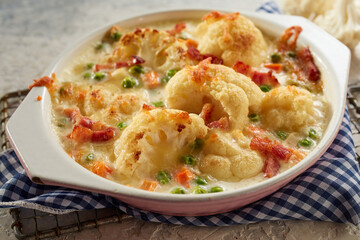 Wall Mural - Bowl with delicious baked cauliflower on table