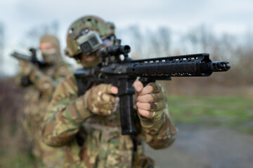 Wall Mural - Two military man with airsoft automatic rifle.