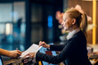 © Dusan Petkovic - A receptionist is working with client and checking in him into a hotel.