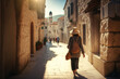 A hot Mediterranean city street with a woman walking down it on her vecation