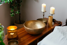 Tibetan Singing Bowl With Aromatic Burning Candles On Table