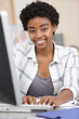 © auremar - young woman working on computer at her desk