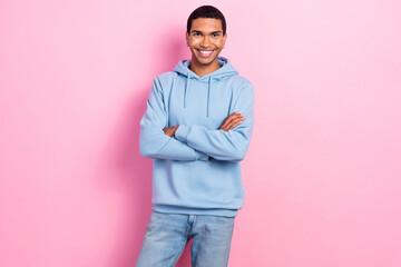 Wall Mural - Photo of satisfied glad young man beaming smile crossed arms posing isolated on pink color background