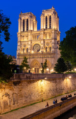 Wall Mural - Notre-Dame de Paris cathedral and Cite island embankment at night, France