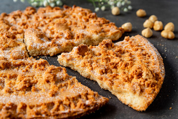 Fregolotta, a traditional italian crumb cake or pie is seen from top on a table. Traditional dessert from the Veneto region and Venice, made with flour, eggs, butter, sugar.