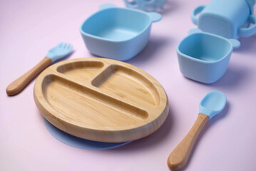 A set of children's silicone dishes. Baby feeding and nutrition concept. Top view, flat lay.