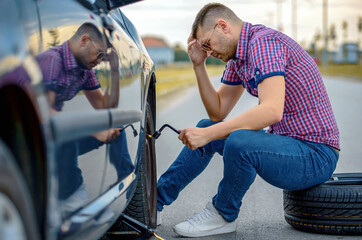 Wall Mural - Driver changing wheel on the vehicle. Transportation, traveling concept