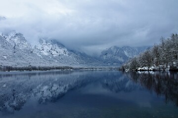 Wall Mural - View of Bohinj lake with forest covered slopes rising above in Julian alps and Triglav national park, Gorenjska, Slovenia