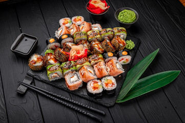 Canvas Print - Big set of Asian food. Sushi and rolls on a dark background.