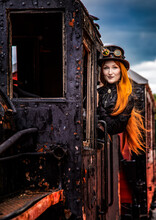 A Waist-high, Red-haired Girl In A Portrait Is Seen Peering Out Of A Train's Window.