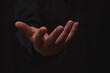 © Kaincloud - open hand with gesture of receiving, on black background, usable for opportunity, giving and business themes.