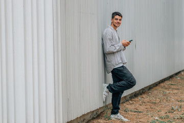 Wall Mural - teenager with mobile phone in the street