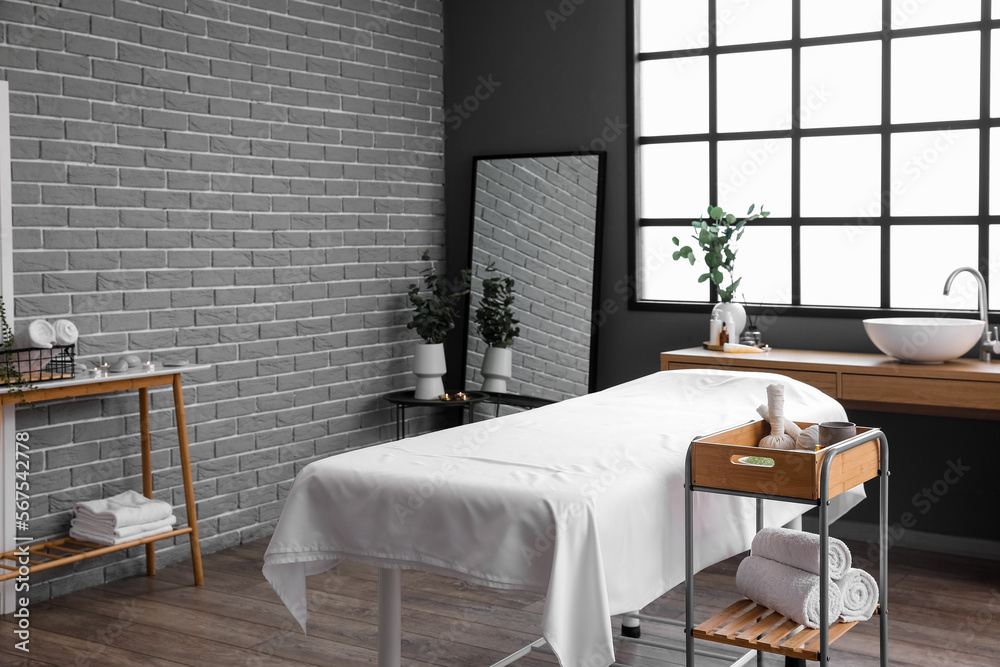 Interior of spa salon with couch and tables