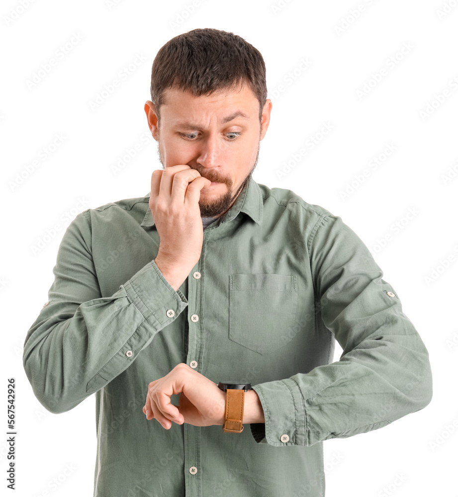 Handsome man with wristwatch biting nails on white background