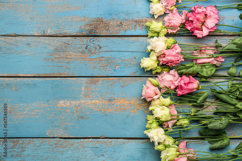 Composition with beautiful eustoma flowers on color wooden background. Hello spring