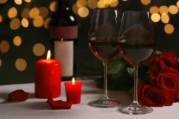 Canvas Print - Romantic table setting with glasses of red wine, rose flowers and burning candles