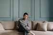 © Sevendeman - Asian man in fleece sitting in the living room in cold weather.