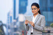 © G-images - Confident businesswoman using a digital tablet.