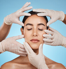 Sticker - Plastic surgery, beauty and hands on the face of a woman isolated on a blue background in a studio. Feeling, skincare and doctors touching a model for a botox, cosmetics or dermatology consultation