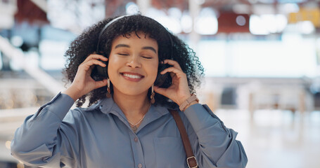 Music, headphones and black woman in mall for freedom, relax and calm energy, dance, listening and happy with her travel journey. Urban building, gen z and audio technology for inspiration in retail