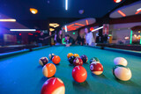 Fototapeta  - Friends and family come together for a leisurely game of billiards, perfect for all skill levels and a timeless activity.