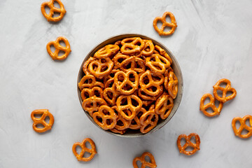 Wall Mural - Mini Pretzels with Salt in a Bowl on a gray background, top view. Flat lay, overhead, from above.