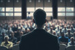 © Antoine - Symposium sur les affaires et l'entrepreneuriat. Conférencier donnant une conférence lors d'une réunion d'affaires. Public dans la salle de conférence. Vue arrière d'un participant (AI)
