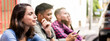 © Davide Zanin - Horizontal banner or header with pensive friends group using smartphone sitting at university college backyard - Young people addicted by mobile smart phone