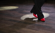 Close-up Of A Male Tango Dancer's Legs In A Ballroom